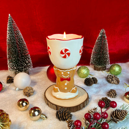 Gingerbread cookie scented ceramic gingerbread goblet candle styled with festive holiday décor and Christmas ornaments.